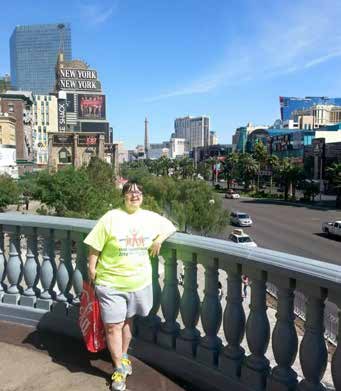 Jennifer standing on a a balcony overlooking a city