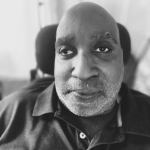 An up close photo of Ricky, a Black man with IDD